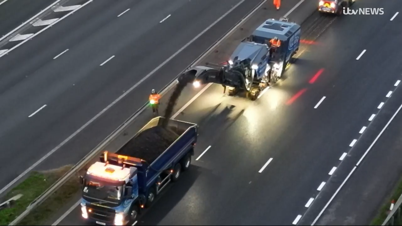 ITV News camera crew filming road planing operations on the M6 motorway at night